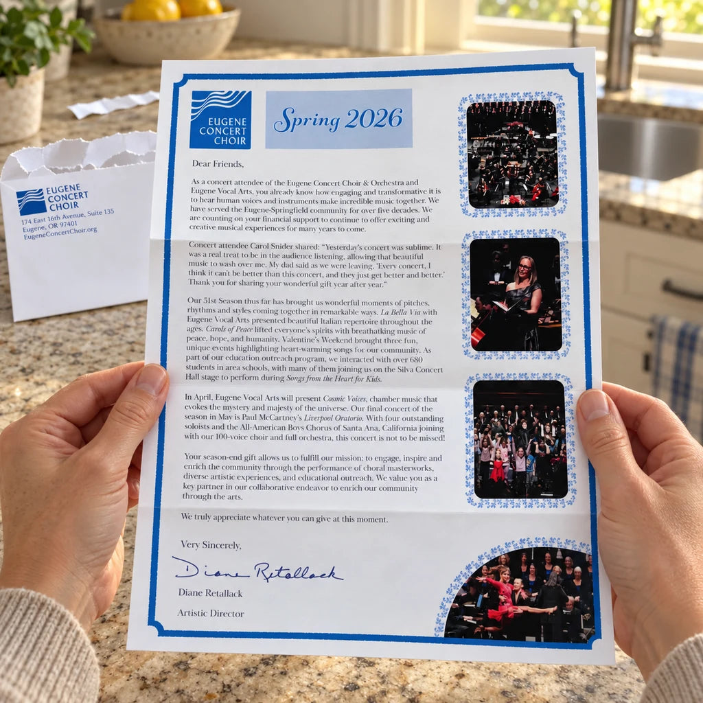 Hands holding an unfolded Eugene Concert Choir letter in a kitchen, with its torn printed envelope on the counter behind it.
