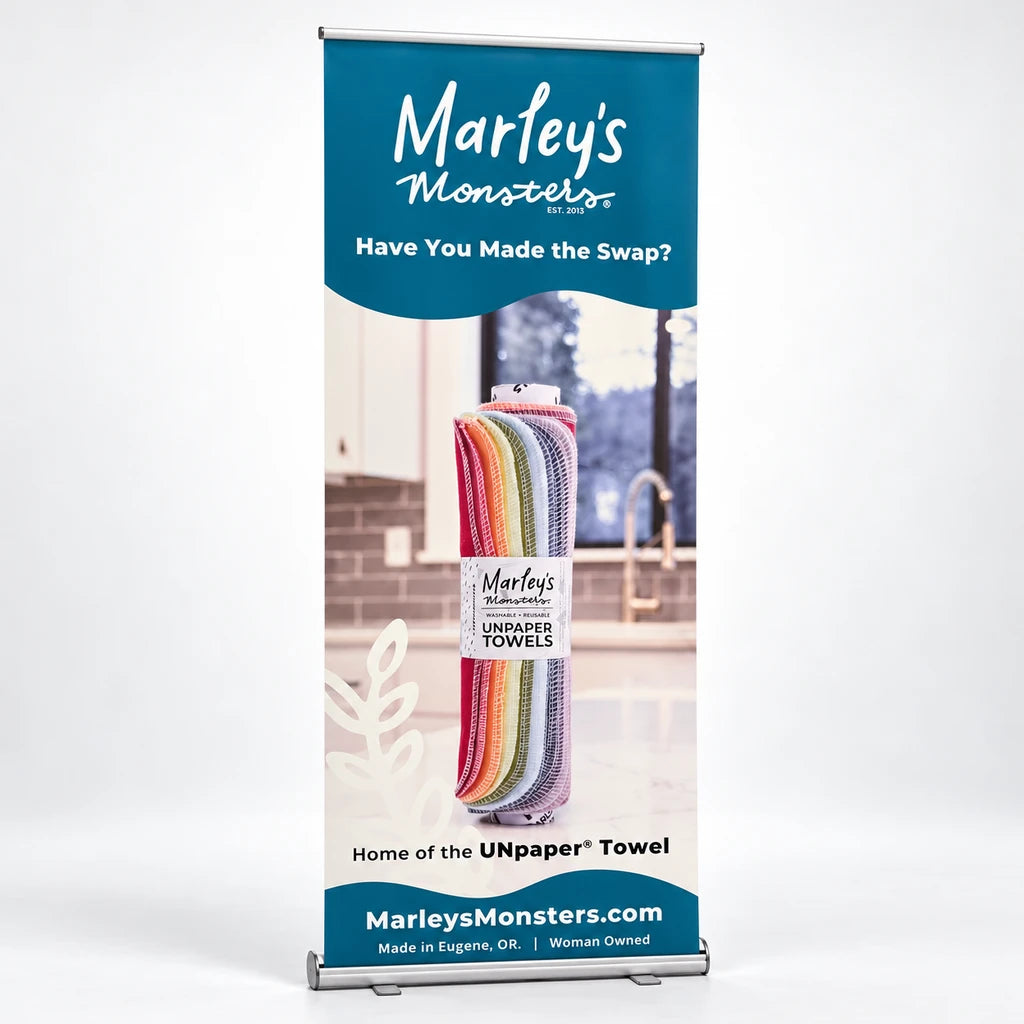 Marley's Monsters retractable banner featuring reusable UNpaper towels, centered on a white studio backdrop.